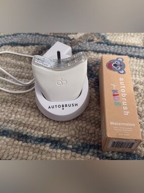 Autobrush Electric Toothbrush Charging Stand - White and brand new toothpaste